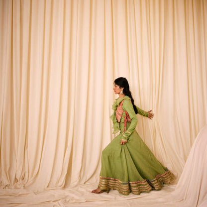 Leela by A Green Blouse With Ruffled Neck Along With Peach Bib And Fully Highlighted Lehenga